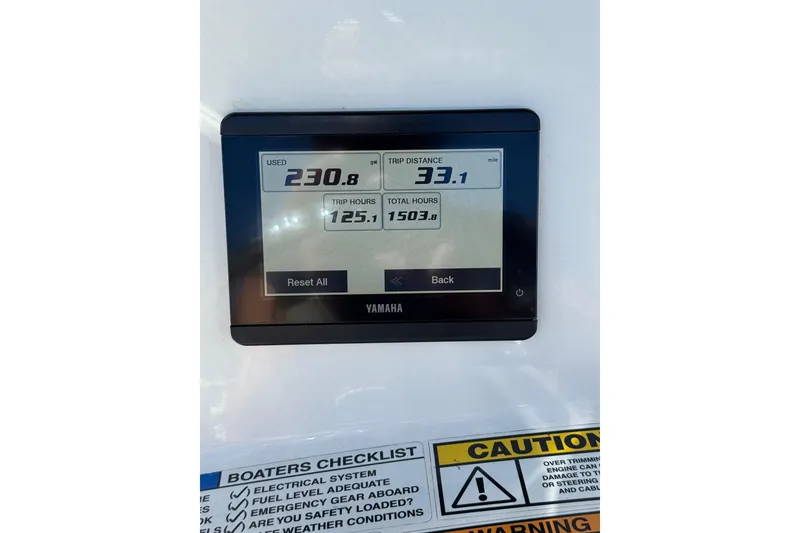 Slide: The Image of Yamaha display on 2023 NauticStar 242L Offshore showing trip data and warnings. - 36