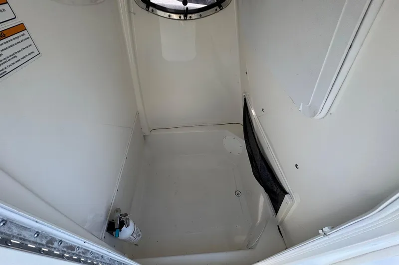 Slide: The Image of Interior of 2023 NauticStar 242L Offshore boat, featuring a compact storage area. - 39