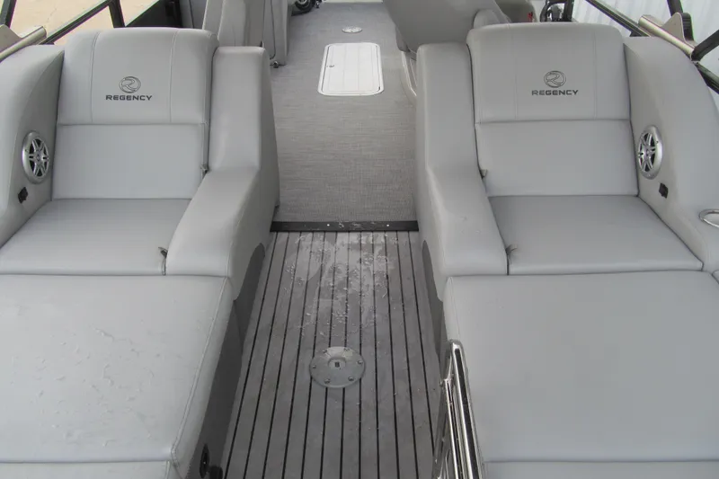 Slide: The Image of 2017 Regency 220 LE3 Sport boat interior with gray seating and flooring. - 5