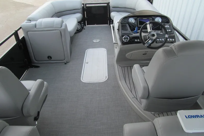 Slide: The Image of 2017 Regency 220 LE3 Sport boat interior with gray seating and modern dashboard. - 7