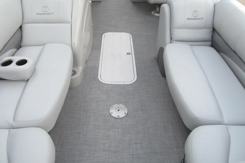 Slide: The Image of 2017 Regency 220 LE3 Sport boat interior with gray seating and cup holders. - 9