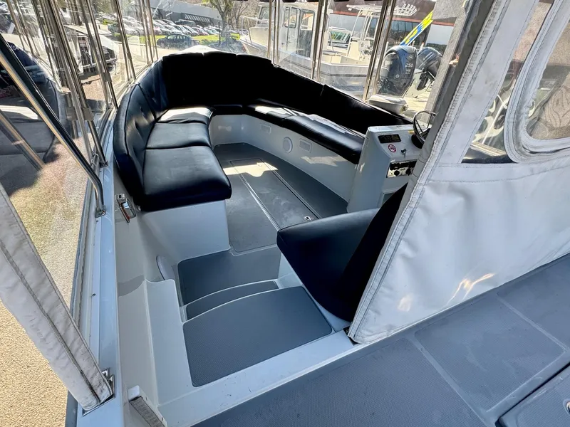 Slide: The Image of 2022 Duffy Sun Cruiser interior with black seating and steering console. - 11