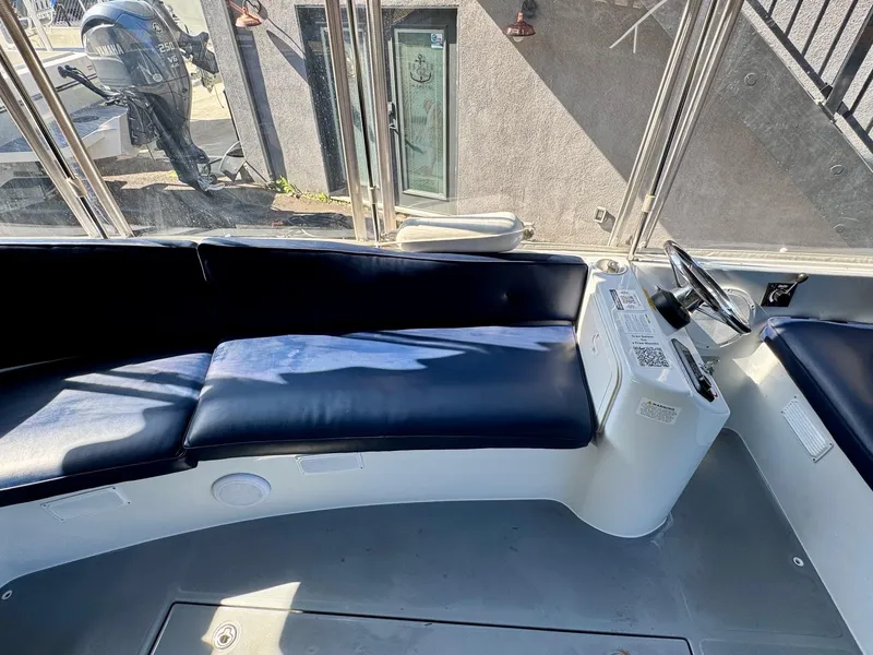 Slide: The Image of 2022 Duffy Sun Cruiser interior with blue seating and steering console. - 18