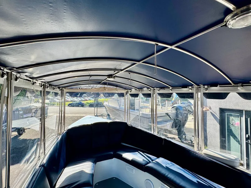 Slide: The Image of Interior view of 2022 Duffy Sun Cruiser boat with blue canopy and seating. - 22