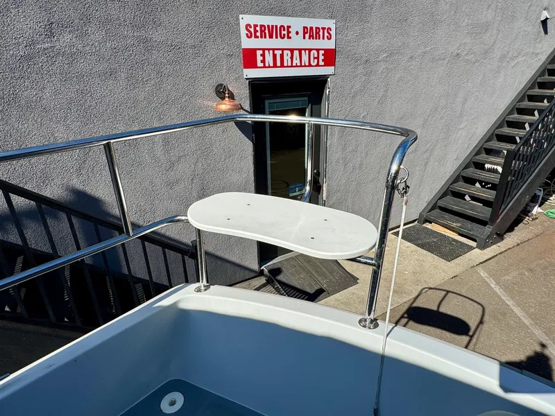 Slide: The Image of 2022 Duffy Sun Cruiser near service entrance, showcasing boat's railing and deck. - 9