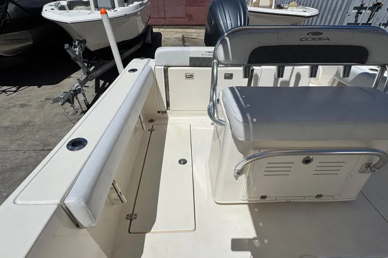 Slide: The Image of 2022 Cobia 237 Center Console boat interior with seating and storage compartments. - 16