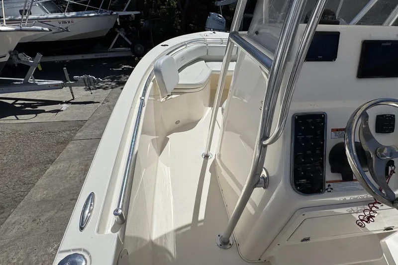 Slide: The Image of 2022 Cobia 237 Center Console boat interior with steering wheel and control panel. - 24