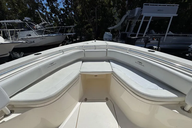 Slide: The Image of 2022 Cobia 237 Center Console boat interior with cushioned seating and railings. - 26
