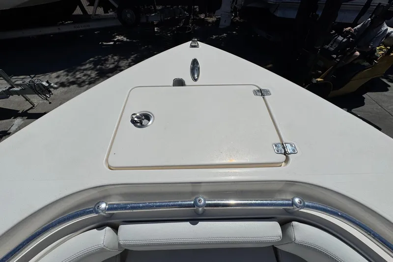 Slide: The Image of 2022 Cobia 237 Center Console boat deck with storage hatch and railing. - 31