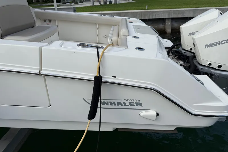 Slide: The Image of 2020 Boston Whaler 330 Outrage boat with dual Mercury engines docked. - 11