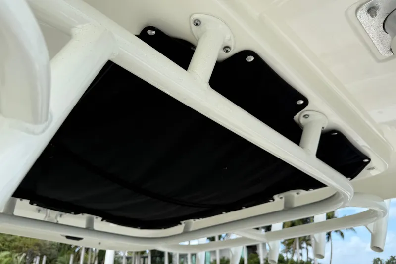 Slide: The Image of 2020 Boston Whaler 330 Outrage T-top frame detail with black canvas. - 17