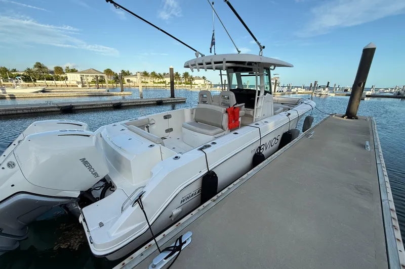 Slide: The Image of 2020 Boston Whaler 330 Outrage docked, featuring dual Mercury engines and spacious seating. - 7