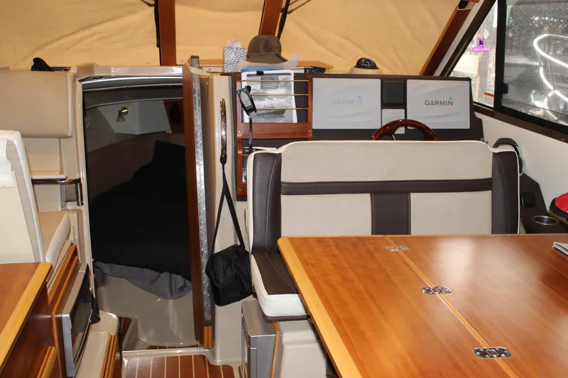 Slide: The Image of Interior of 2016 Cutwater 30 Command Bridge with wood accents and Garmin navigation. - 10