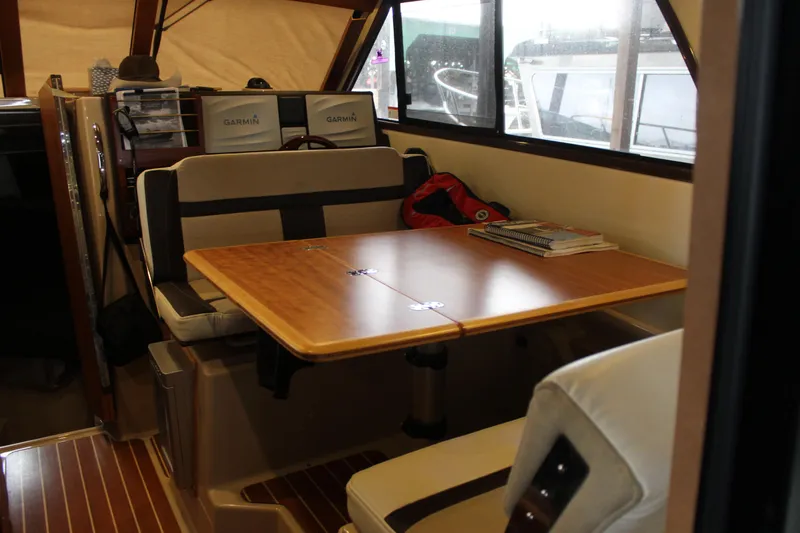 Slide: The Image of Interior of 2016 Cutwater 30 Command Bridge with dining table and seating area. - 17