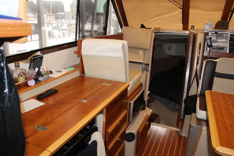 Slide: The Image of 2016 Cutwater 30 Command Bridge interior with wood finish and cozy cabin space. - 18