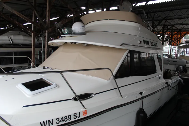 Slide: The Image of 2016 Cutwater 30 Command Bridge boat docked in a covered marina. - 21