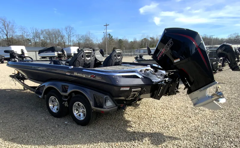 Slide: The Image of 2026 Ranger Z Comanche Z520R Ultra boat on gravel lot. - 11