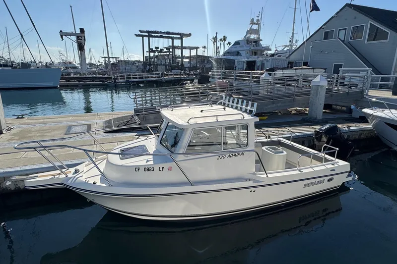 Slide: The Image of 2023 Defiance Admiral 220 EX boat docked at marina, sunny day. - 4