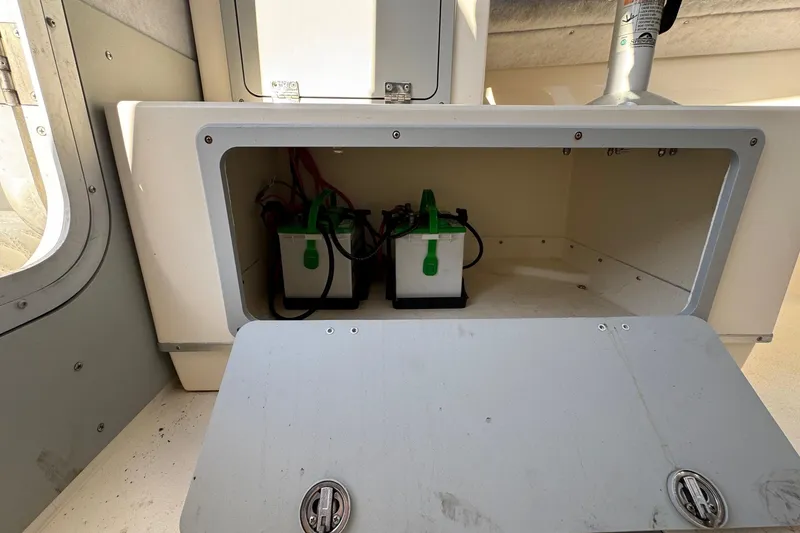 Slide: The Image of 2023 Defiance Admiral 220 EX boat battery compartment with two batteries. - 42