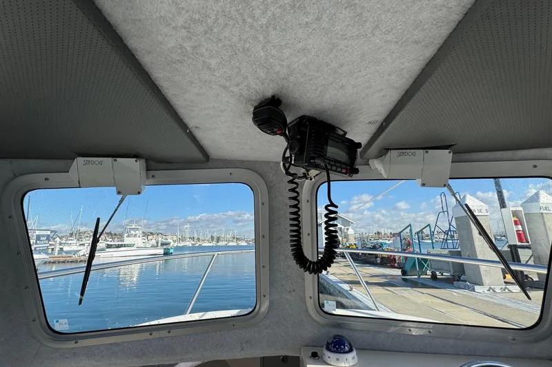 Slide: The Image of Interior view of 2023 Defiance Admiral 220 EX boat at marina dock. - 47