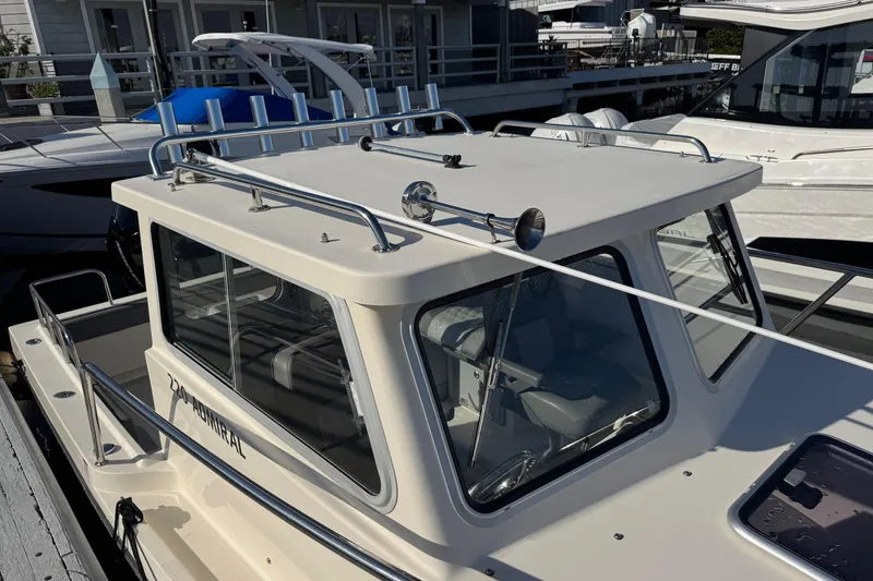 Slide: The Image of 2023 Defiance Admiral 220 EX boat docked, featuring a sturdy cabin and sleek design. - 50