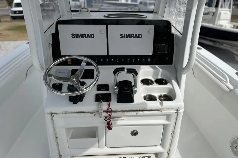 Slide: The Image of 2018 Sea Hunt Gamefish 27 console with Simrad displays and steering wheel. - 10