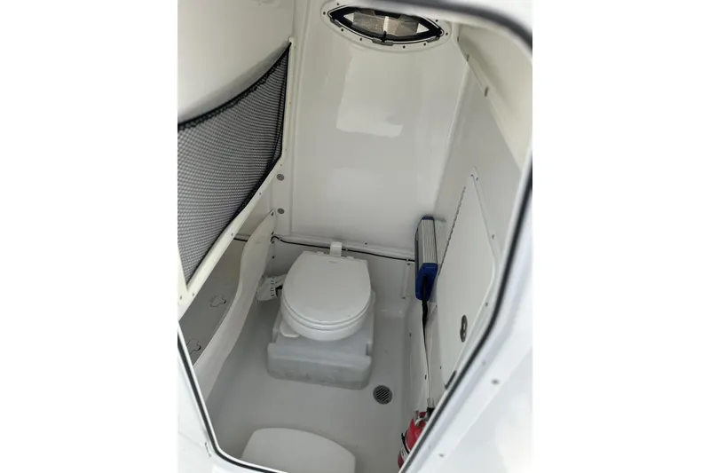 Slide: The Image of 2018 Sea Hunt Gamefish 27 boat interior with compact marine toilet. - 12