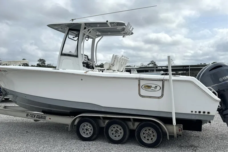 Slide: The Image of 2018 Sea Hunt Gamefish 27 boat on trailer, featuring forward seating and Yamaha engine. - 5