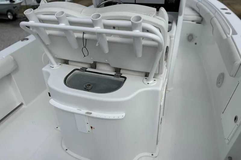 Slide: The Image of 2018 Sea Hunt Gamefish 27 boat interior with rod holders and storage compartment. - 7