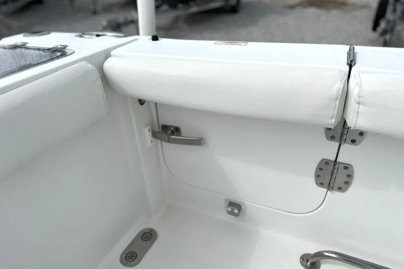 Slide: The Image of 2018 Sea Hunt Gamefish 27 boat interior with white cushioned seating and stainless steel fittings. - 8