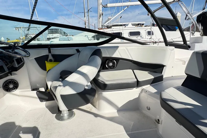 Slide: The Image of 2024 Regal 21 OBX boat interior with modern seating and steering wheel. - 15