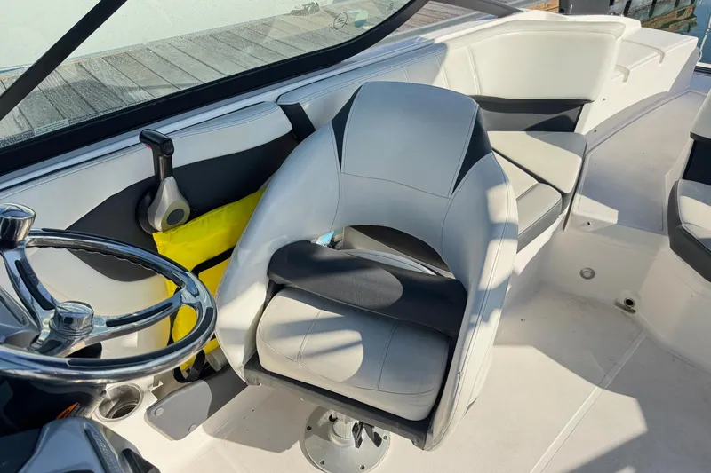 Slide: The Image of 2024 Regal 21 OBX boat interior with steering wheel and seating. - 17