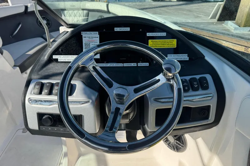 Slide: The Image of 2024 Regal 21 OBX boat steering wheel and dashboard controls. - 18