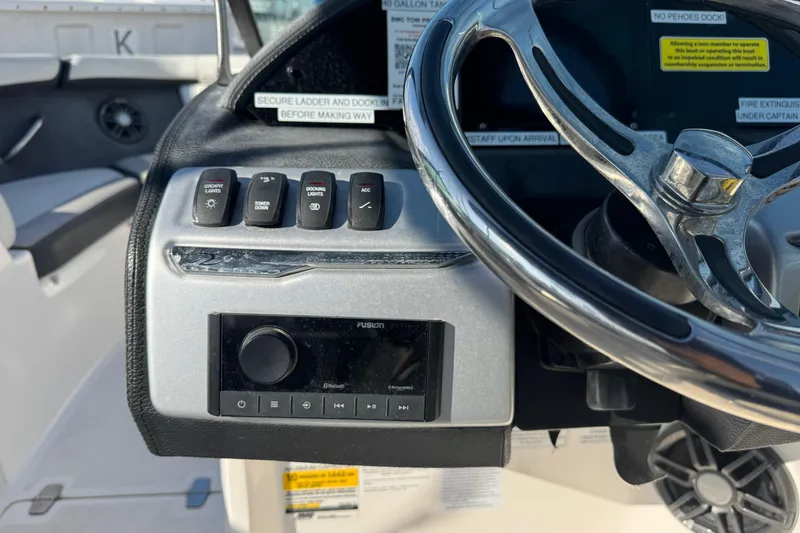 Slide: The Image of 2024 Regal 21 OBX boat dashboard with steering wheel and control panel. - 19