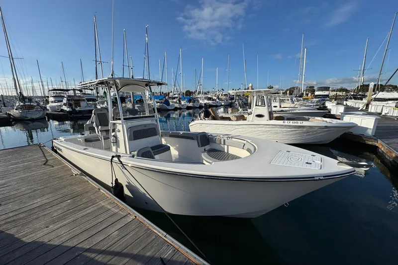 Slide: The Image of 2025 Defiance Catalina 240 boat docked at a marina with clear skies. - 10