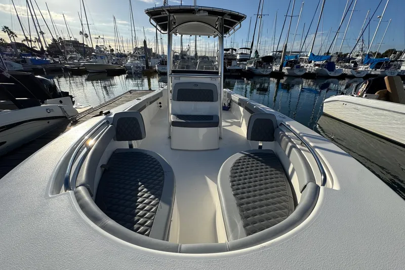 Slide: The Image of 2025 Defiance Catalina 240 boat docked in marina, featuring sleek seating and modern design. - 16