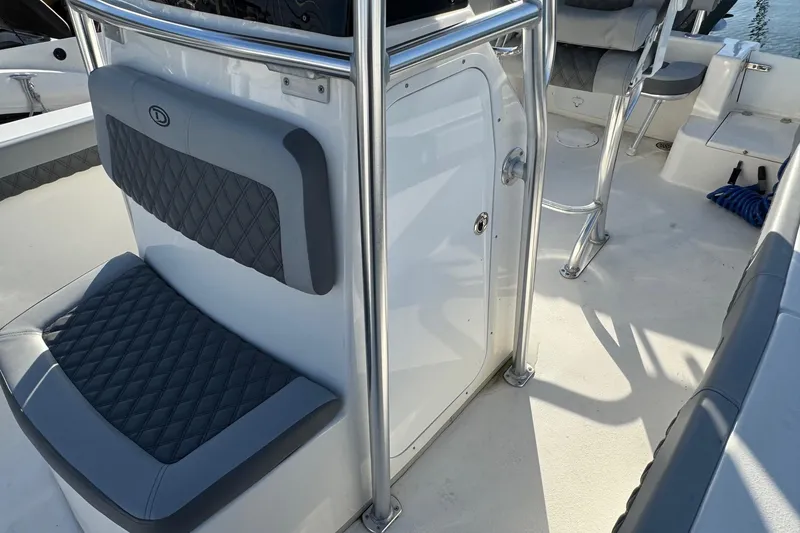Slide: The Image of 2025 Defiance Catalina 240 boat interior with cushioned seating and stainless steel railings. - 19