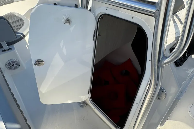 Slide: The Image of Open storage compartment on 2025 Defiance Catalina 240 boat with life jackets inside. - 21