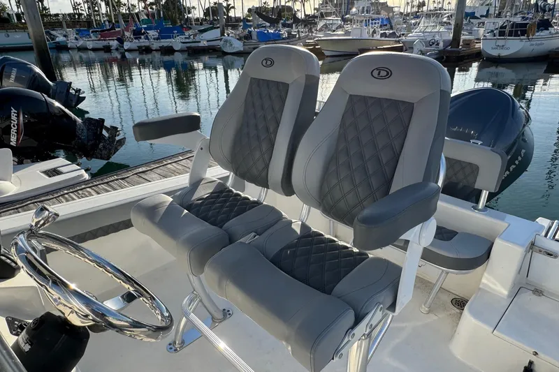 Slide: The Image of Luxury seating on 2025 Defiance Catalina 240 boat, docked with scenic marina backdrop. - 24