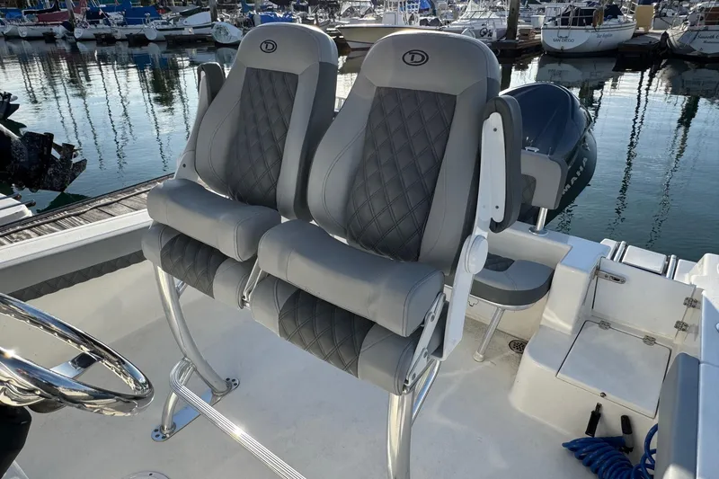 Slide: The Image of 2025 Defiance Catalina 240 boat seats with diamond stitching, docked at a marina. - 25