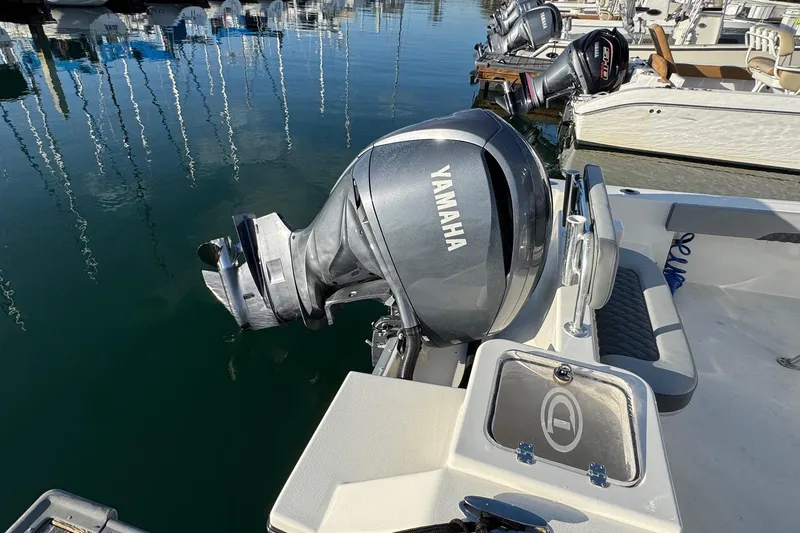 Slide: The Image of 2025 Defiance Catalina 240 with Yamaha outboard motor docked at marina. - 38