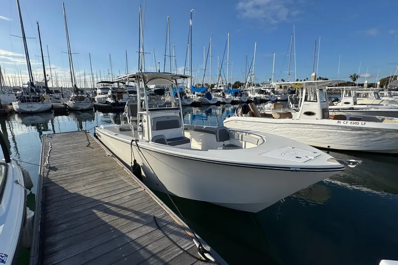 Slide: The Image of 2025 Defiance Catalina 240 boat docked in a marina with sailboats in the background. - 9