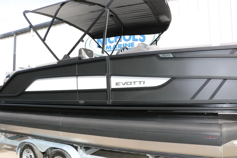 Slide: The Image of 2026 Evotti 521QL boat with sleek black design and canopy, displayed on a trailer. - 18