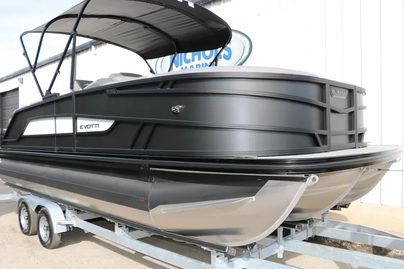 Slide: The Image of 2026 Evotti 521QL pontoon boat on trailer, sleek black design, outdoor display. - 2