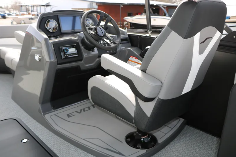 Slide: The Image of Captain's seat and dashboard of 2026 Evotti 521QL boat, featuring modern controls and steering. - 34