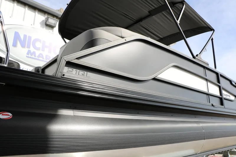 Slide: The Image of 2026 Evotti 521QL pontoon boat with sleek design and canopy, displayed outdoors. - 59