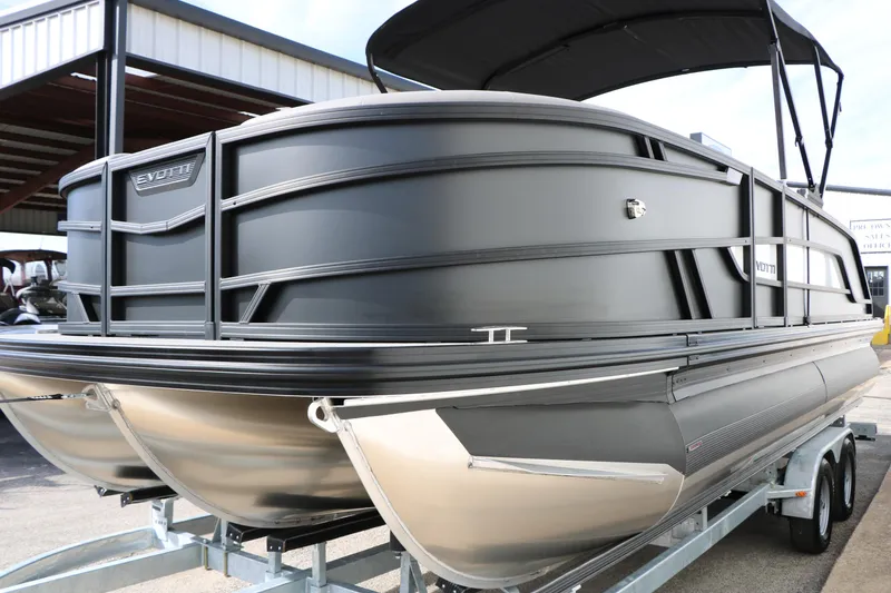 Slide: The Image of 2026 Evotti 521QL pontoon boat on trailer, sleek black design, under a canopy. - 6