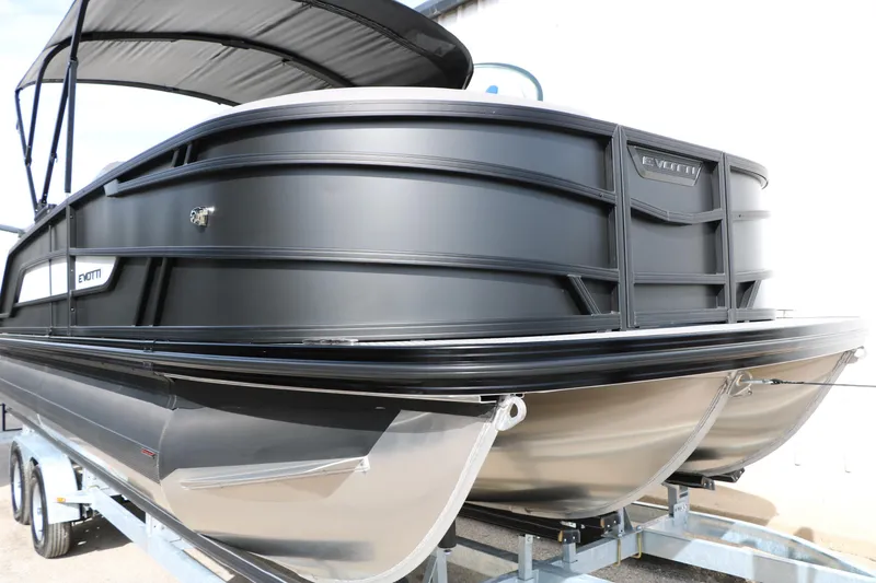 Slide: The Image of 2026 Evotti 521QL pontoon boat with sleek black design on a trailer. - 62