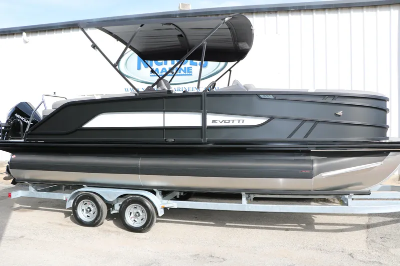 Slide: The Image of 2026 Evotti 521QL pontoon boat on trailer, sleek black design, outdoor display. - 9