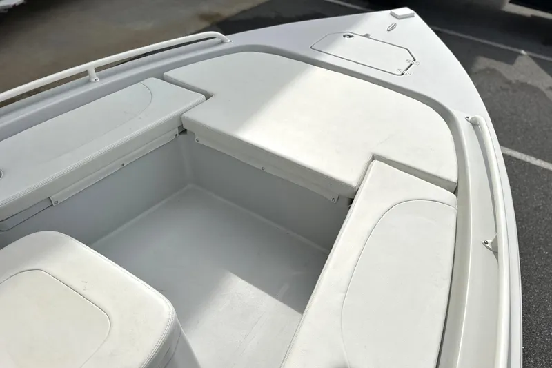 Slide: The Image of 2024 Pathfinder 2200 TRS boat interior with white seating and storage compartments. - 16